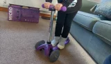 Child standing on Micro scooter