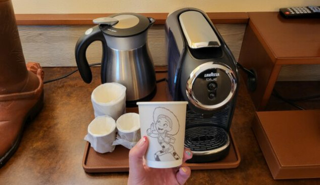 Kettle, coffee machine and a paper cup featuring Jesse from Toy Story
