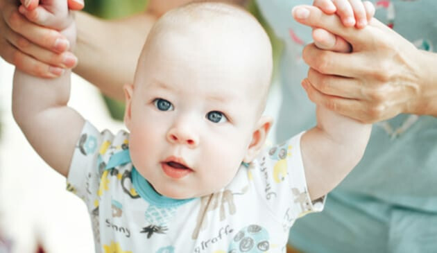 Baby being helped to stand