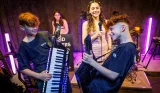 A group of young teenagers play in a band together at WeJam in London