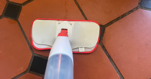 Mumsnet home editor Poppy O'Neill testing the OXO Good Grips Microfibre Spray Mop