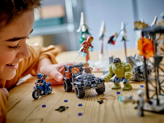 A young boy plays with LEGO's The Avengers Assemble: Age of Ultron