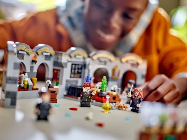 A young boy please with LEGO's Hogwarts™ Castle: Potions Class