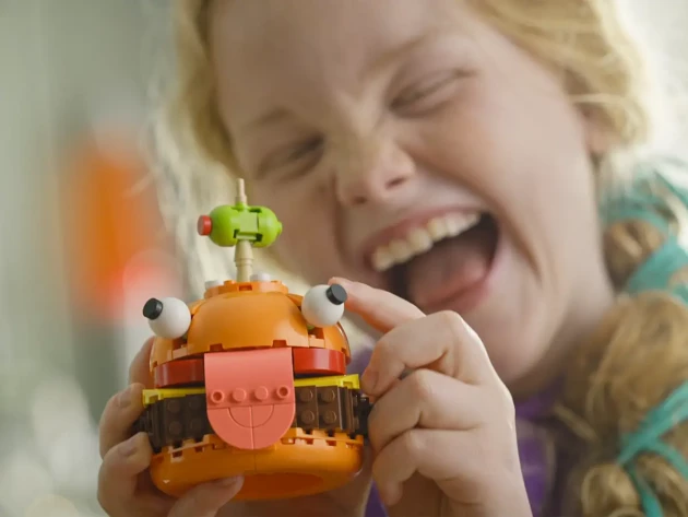 A child playing with LEGO® x Fortnite Durrr Burger
