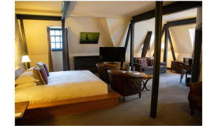 a rustic hotel room with wooden beams