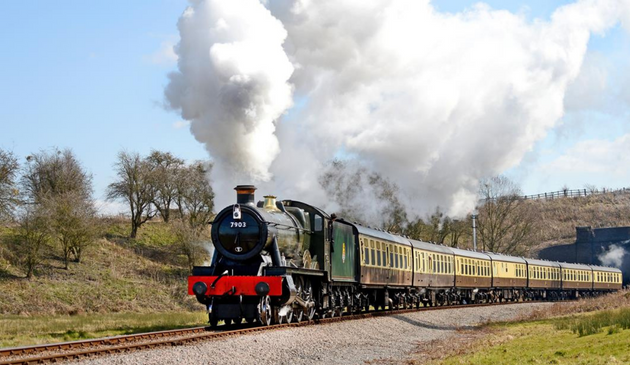 a steam train with billowing steam