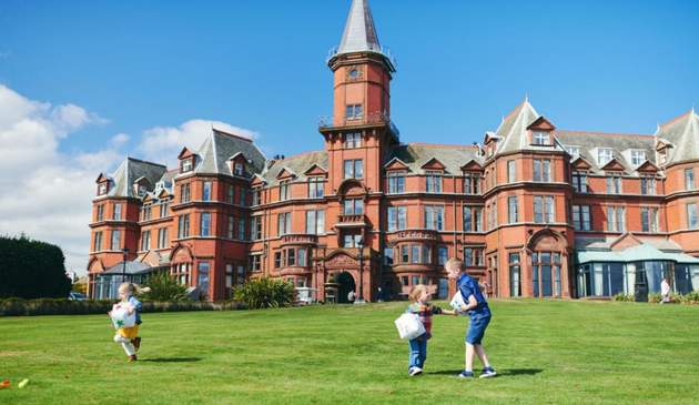Slieve Donard, a grand red-brick hotel with children playing on the lawn