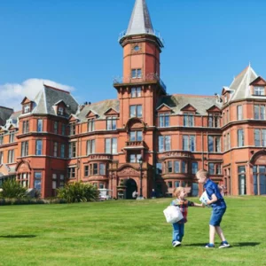 Slieve Donard, a grand red-brick hotel with children playing on the lawn