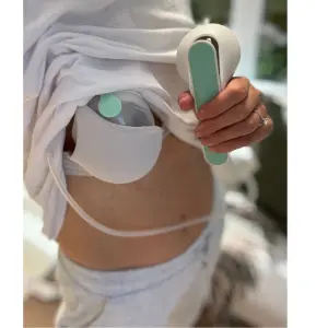 Mum using Elvie wave breast pump