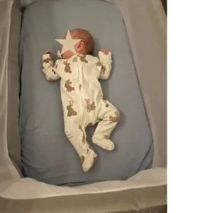 Baby napping in Mamas & Papas Lua Bedside Crib