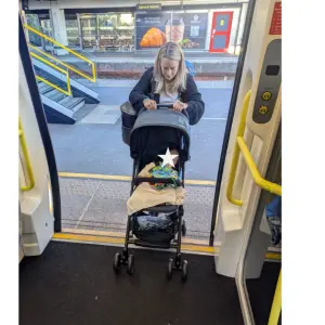 mum pushing baby onto train in Maxi-Cosi Lara 2