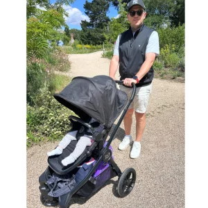 father pushes child in baby jogger city sights stroller