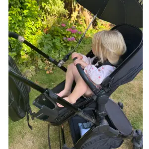 Child in Ickle Bubba Stomp Luxe Elements Edition travel system