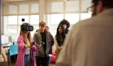 A group of further education students using a VR headset in class
