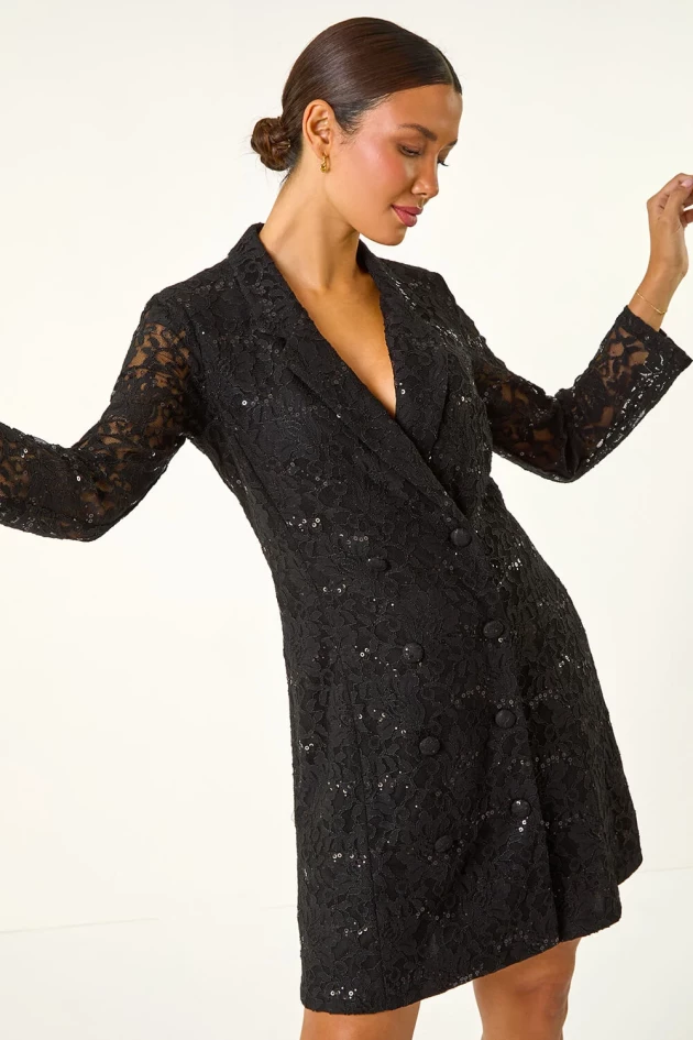 A model wears Roman's Black Sequin Lace Blazer Dress,