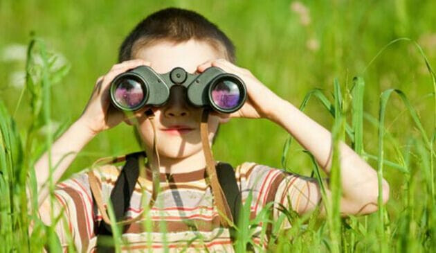 Child looking through binoculars