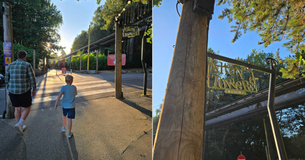 Adult and child walking towards the Rollercoaster Restaurant beneath the Alton Towers sign and monorail