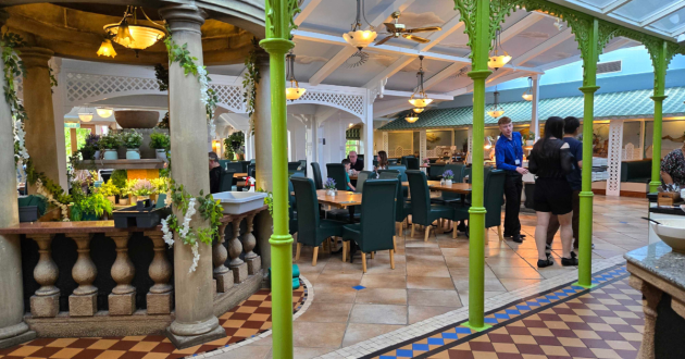 Interior of the Secret Garden Restaurant with green columns and tables