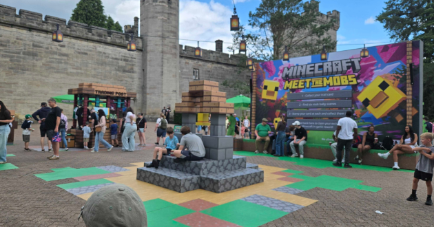 Minecraft Meet the Mobs Hub outside the castle, with activity boards and seating