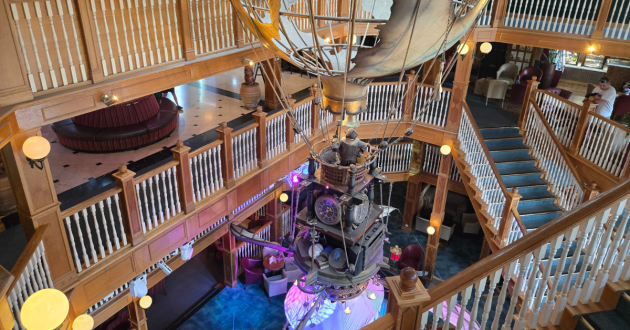 Large explorer-themed hot-air balloon installation hanging through the hotel Atrium