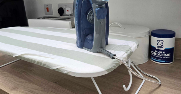 Steam iron standing on the Argos Home Table Top Ironing Board during testing