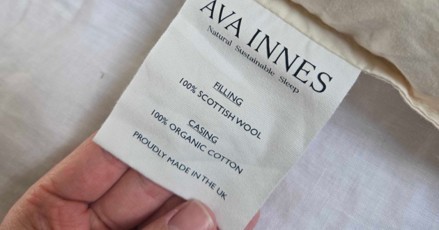 A close up of the care label on the Ava Innes pillow