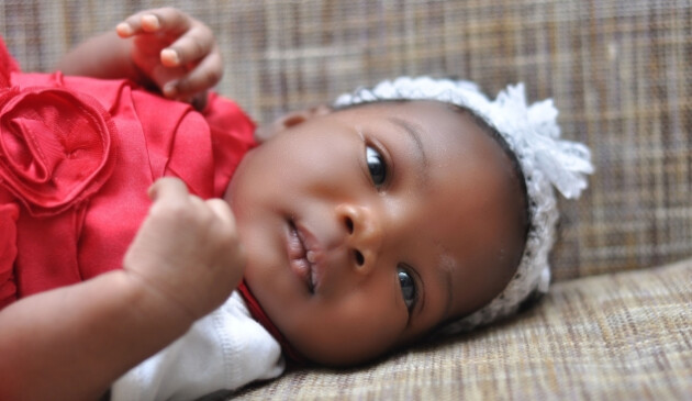 Baby girl lying on sofa