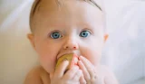 cute baby with block in mouth
