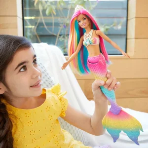 Child playing with Barbie Dreamtopia Rainbow Magic Mermaid Doll