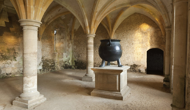 a cauldron in a vaulted room