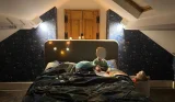 child sitting in bed reading a story testing the Hypnos Ortho Wool mattress