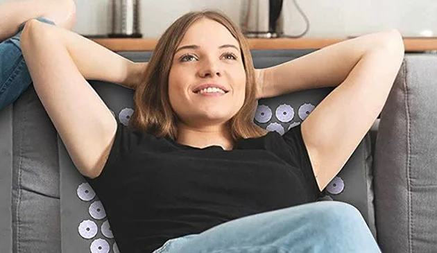 Woman using acupressure mat