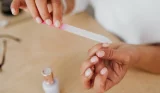 woman filing nails at home
