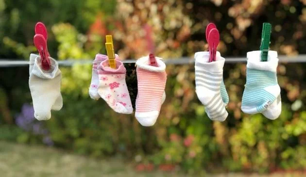 Baby socks hanging on washing line