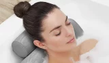 Woman having bath with bath pillow