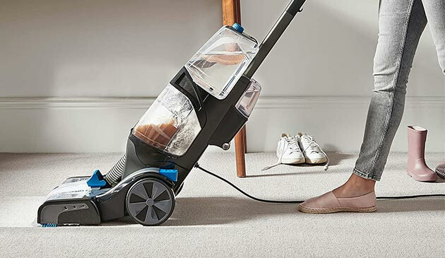 Woman using Vax carpet cleaner