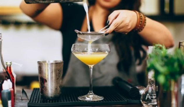 Woman making a cocktail