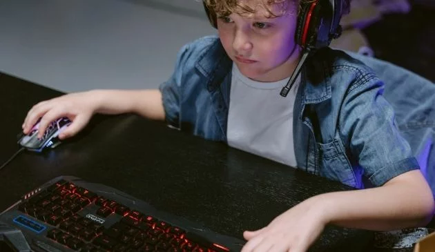 child gaming with headset on