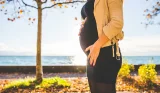 Woman in tights holding bump