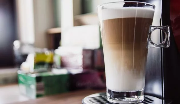 A latte glass filled with fresh coffee