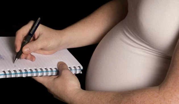Woman writing a birth plan