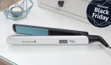Remington Shine Therapy hair straighteners placed on a bedside table with the Mumsnet Black Friday badge overlayed