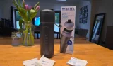 Blue BRITA Active bottle beside its box, two wrapped MicroDiscs and instructions on a wooden table