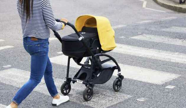 woman pushing bugaboo bee 6 pushchair across street