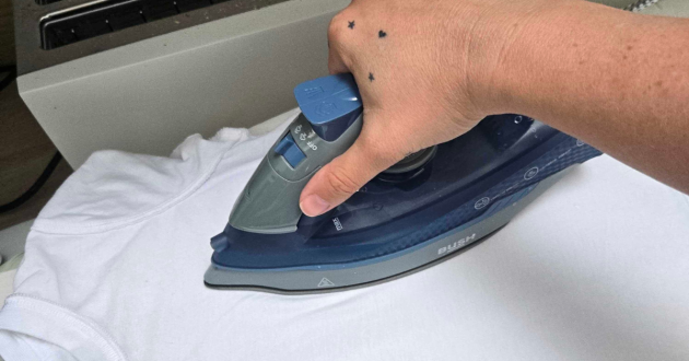 Close up of the tester's hand using the Bush ES2475 Steam Iron review