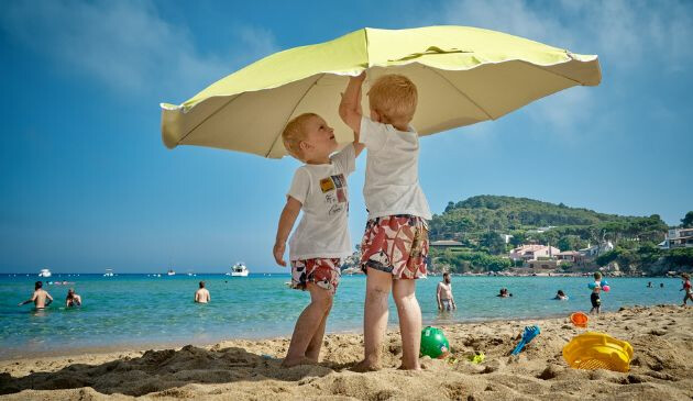 Toddlers on the beach at Cala de la Fosca, Spain