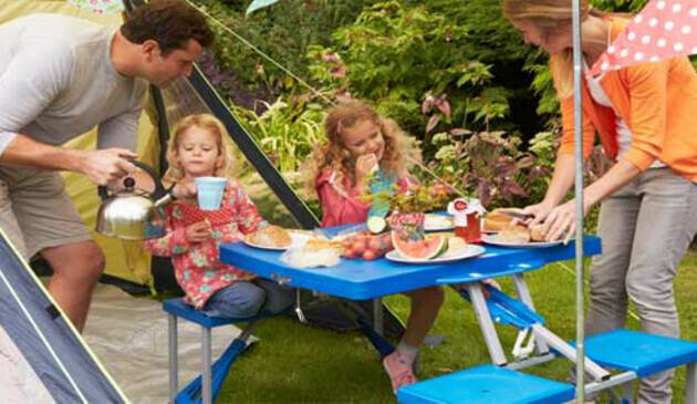 Family eating dinner outside tent
