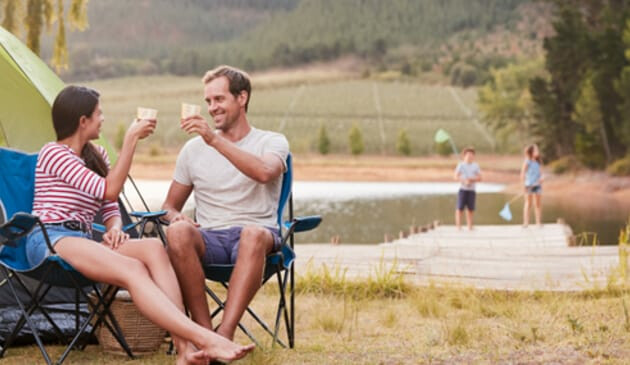 Couple drinking wine outside tent