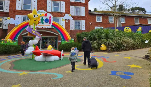 A family walking into the entrance of the CBeebies Land Hotel