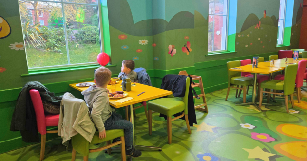 Children eating at a table inside the CBeebies Land Hotel